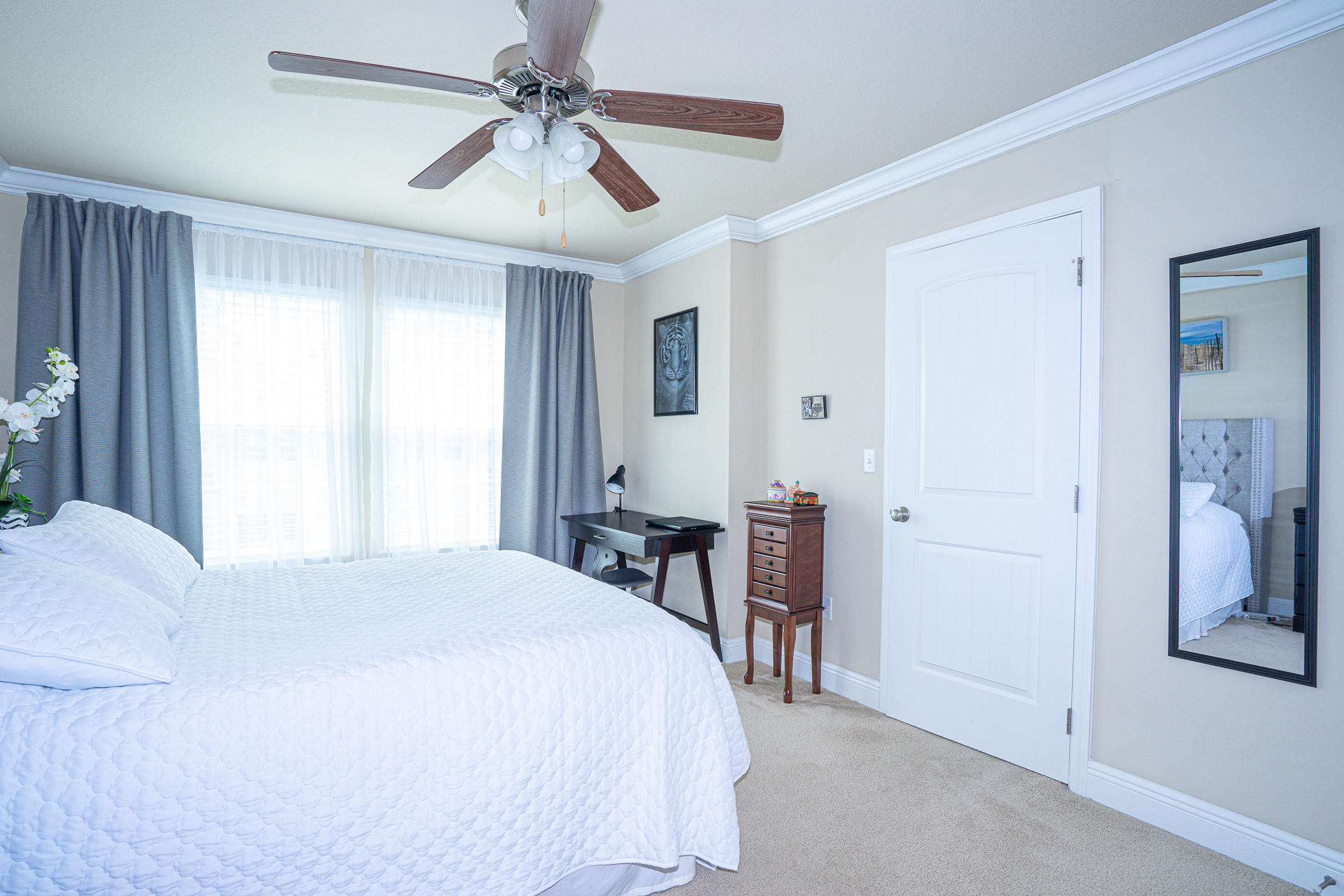 19 East Shady Oaks Lane, Unit B Santa Rosa Beach, FL 32459 - Photo 20 of 35 a bedroom with a bed and a chandelier