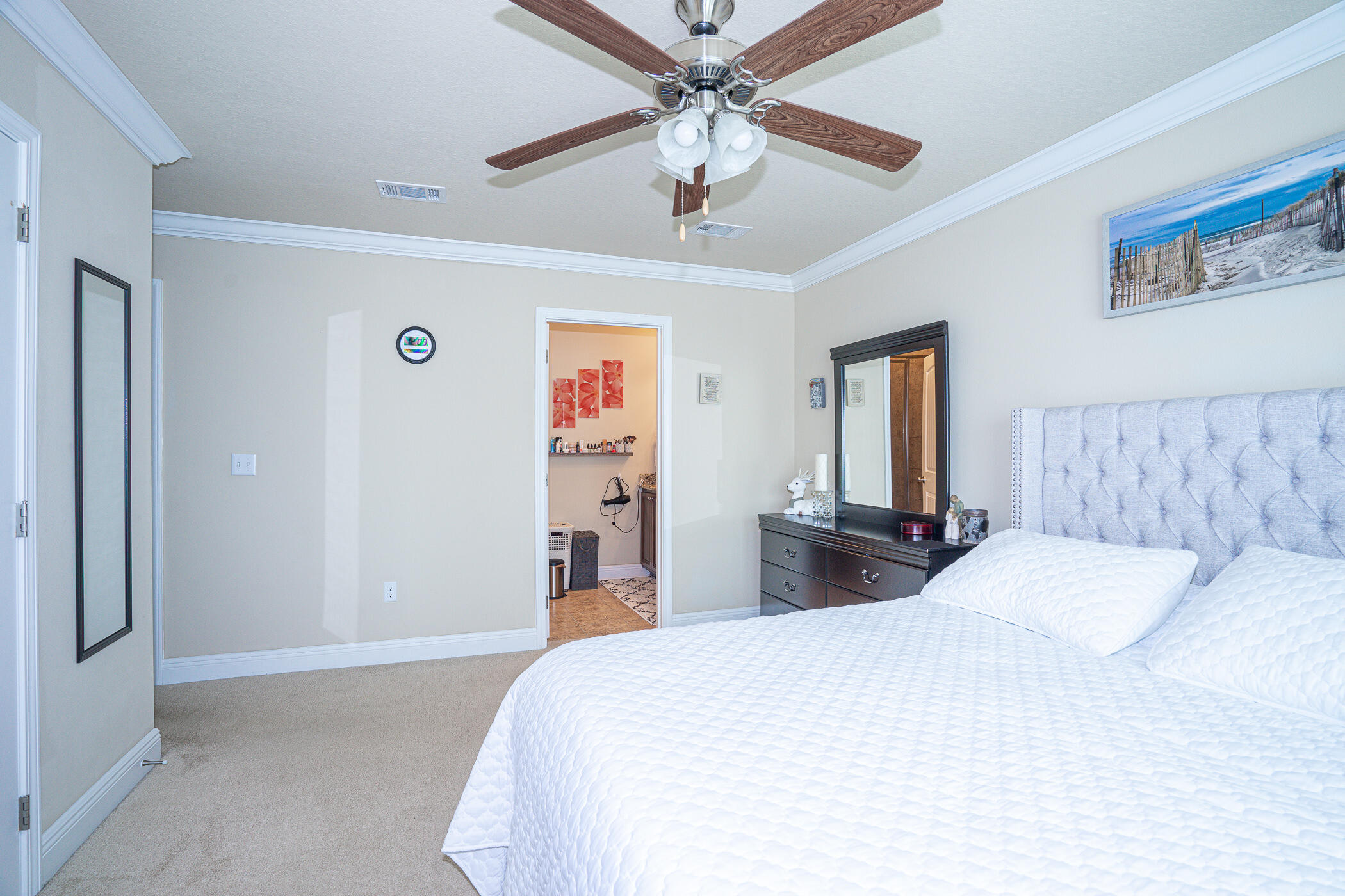 19 East Shady Oaks Lane, Unit B Santa Rosa Beach, FL 32459 - Photo 22 of 35 a bedroom with a bed and a chandelier