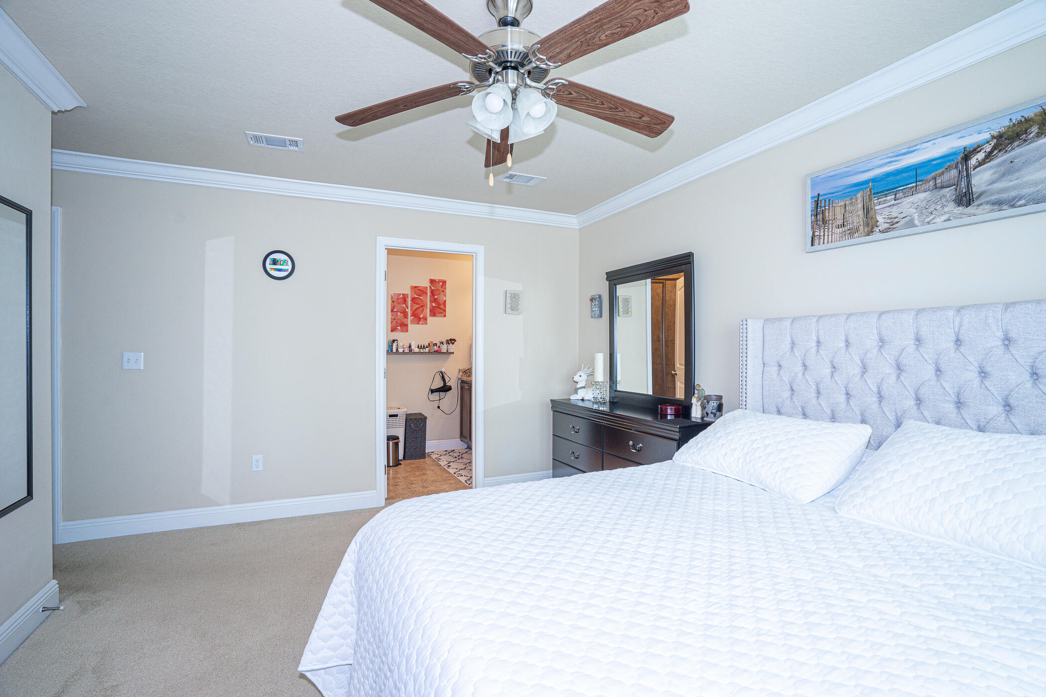 19 East Shady Oaks Lane, Unit B Santa Rosa Beach, FL 32459 - Photo 23 of 35 a bedroom with a large bed and a chandelier