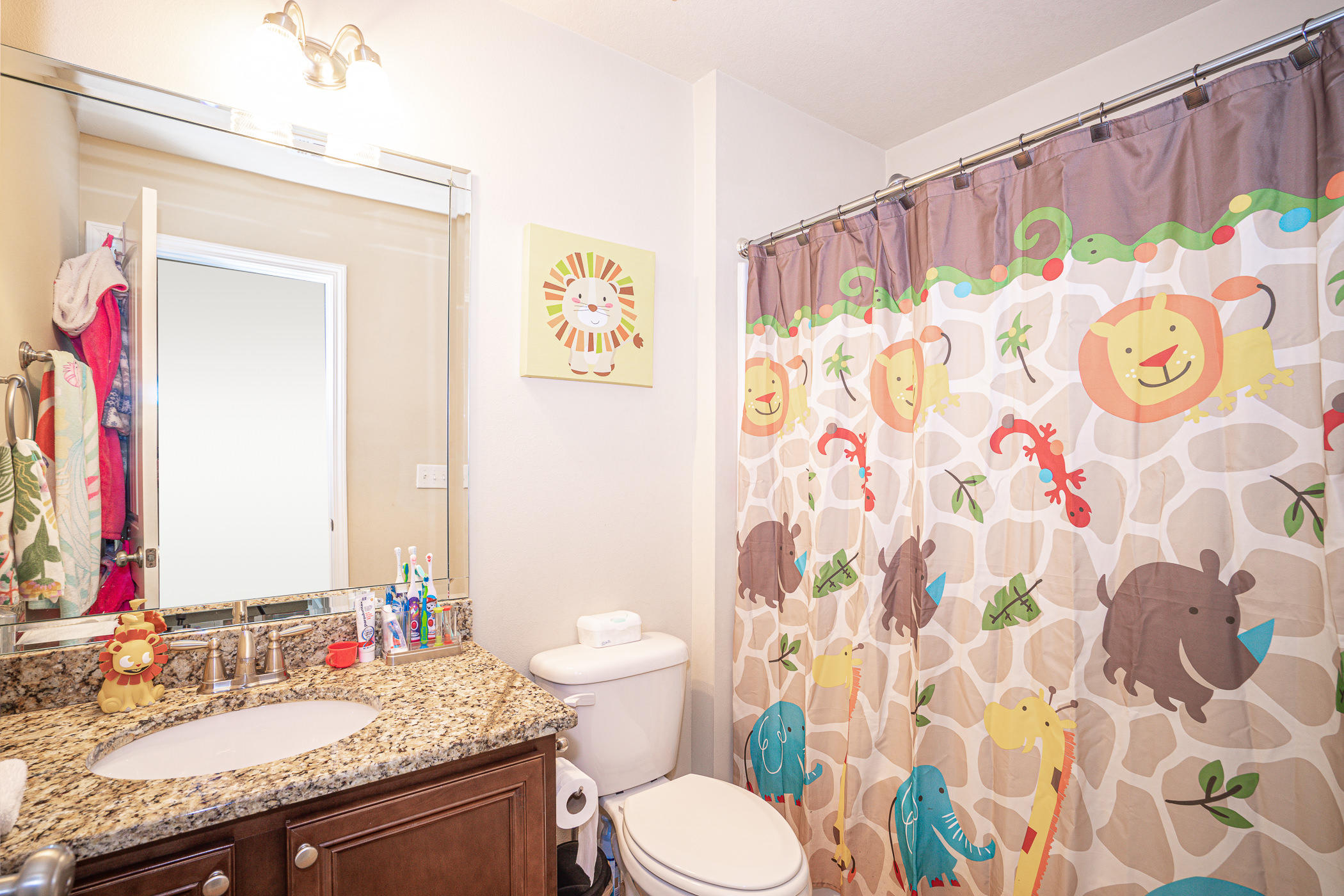 19 East Shady Oaks Lane, Unit B Santa Rosa Beach, FL 32459 - Photo 30 of 35 a bathroom with a granite countertop sink a toilet and a mirror