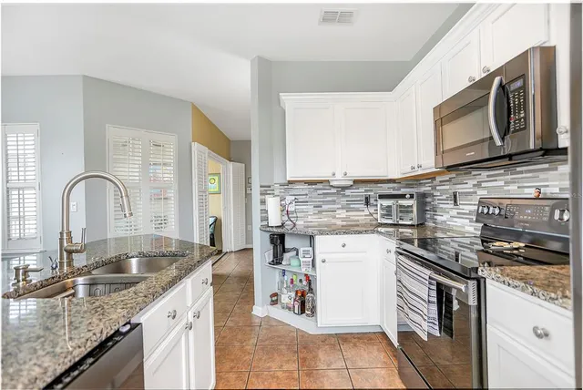 a kitchen with a stove microwave and sink