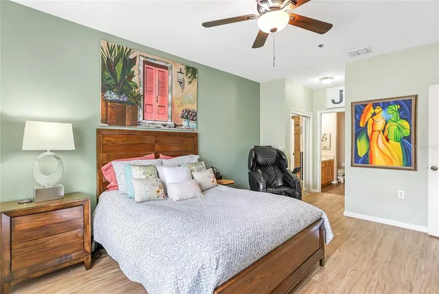 a bedroom with a bed and wooden floor