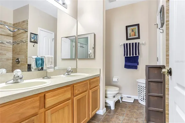 a spacious bathroom with a toilet sink and mirror