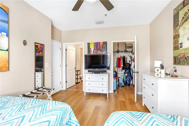 a bedroom with a bed and a flat screen tv