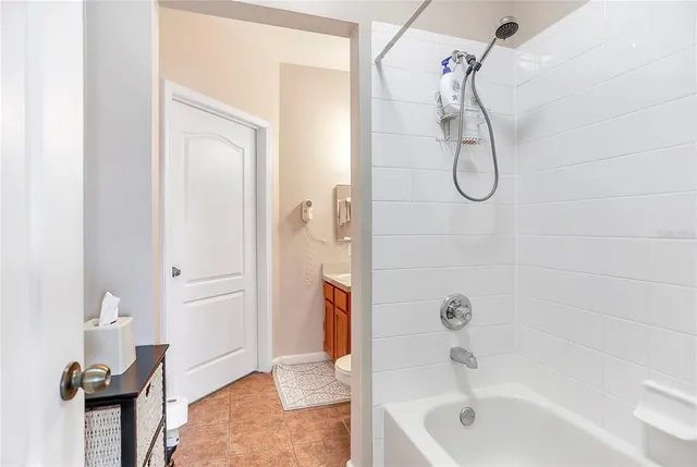 a bathroom with a bath tub with a shower