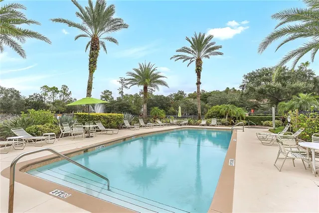 a view of a swimming pool with a table and chairs