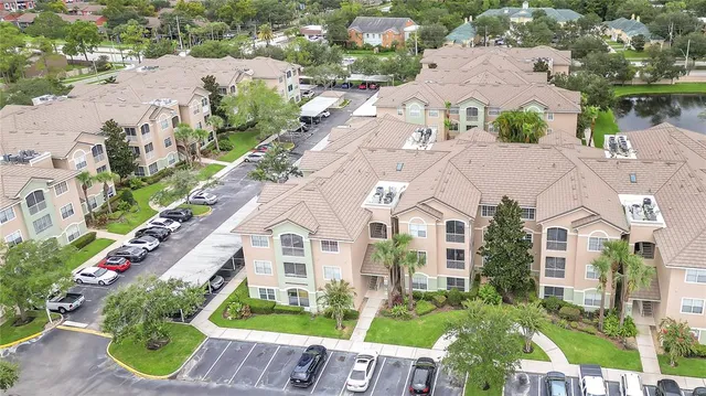 an aerial view of multiple houses with yard