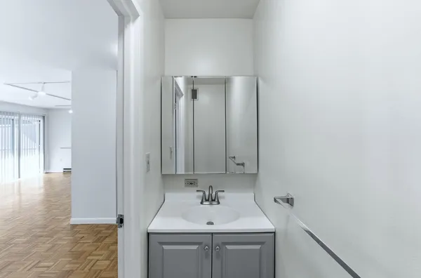a bathroom with a sink a toilet and mirror