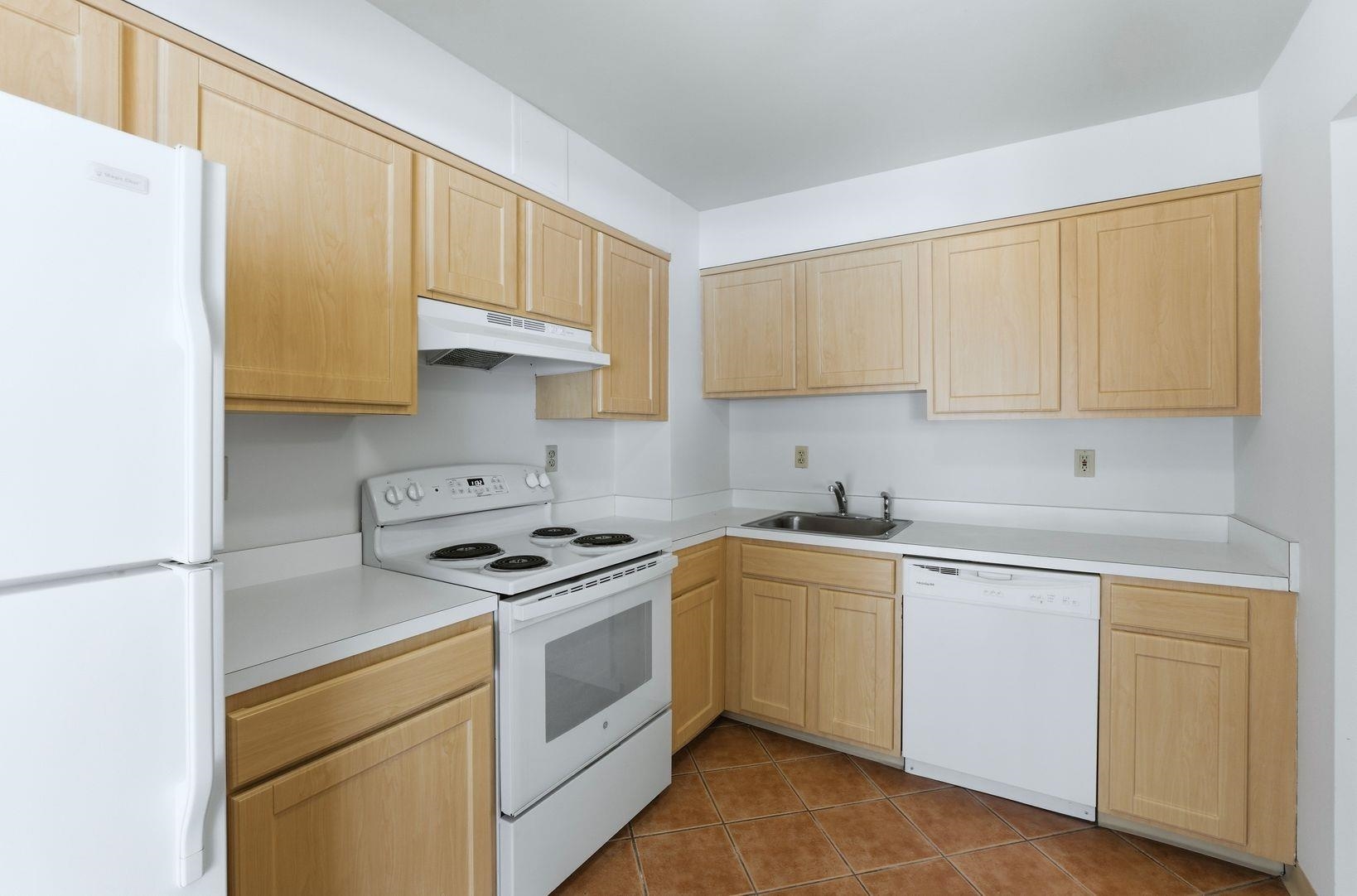 1111 River Road, Unit C6 Edgewater, NJ 07020 - Photo 4 of 16 a kitchen with a stove sink and cabinets