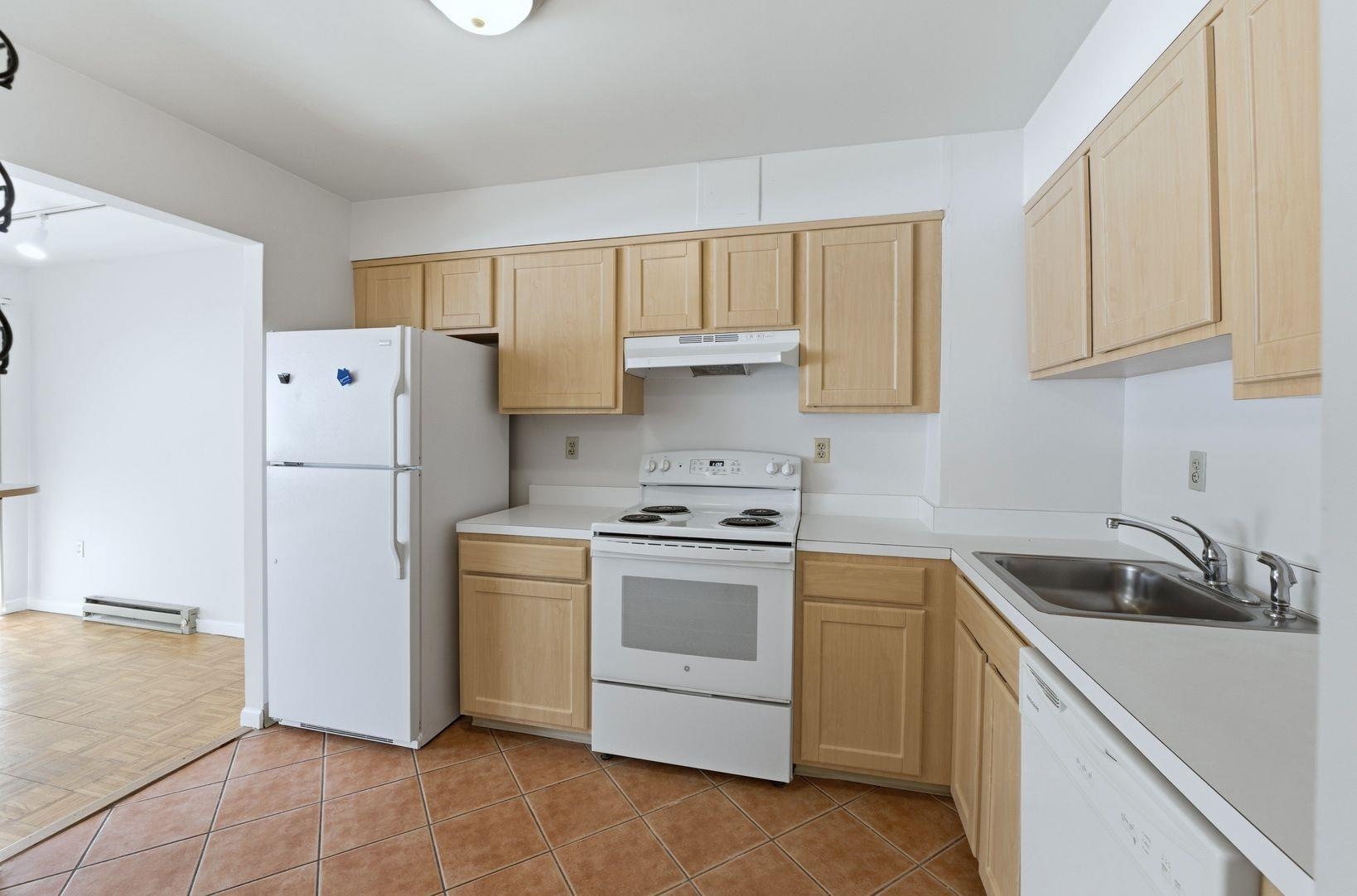 1111 River Road, Unit C6 Edgewater, NJ 07020 - Photo 5 of 16 a kitchen with a stove sink and refrigerator