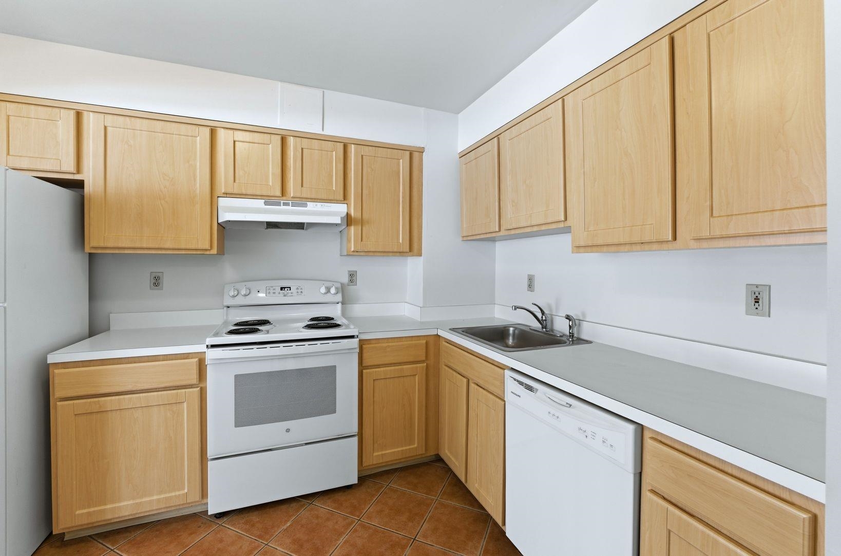 1111 River Road, Unit C6 Edgewater, NJ 07020 - Photo 6 of 16 a kitchen with a sink stove and cabinets