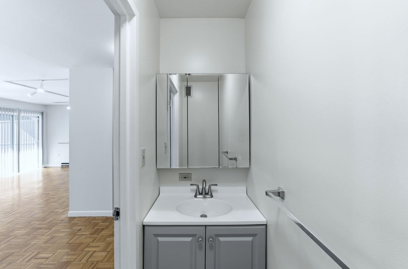 1111 River Road, Unit C6 Edgewater, NJ 07020 - Photo 9 of 16 a bathroom with a sink a toilet and mirror