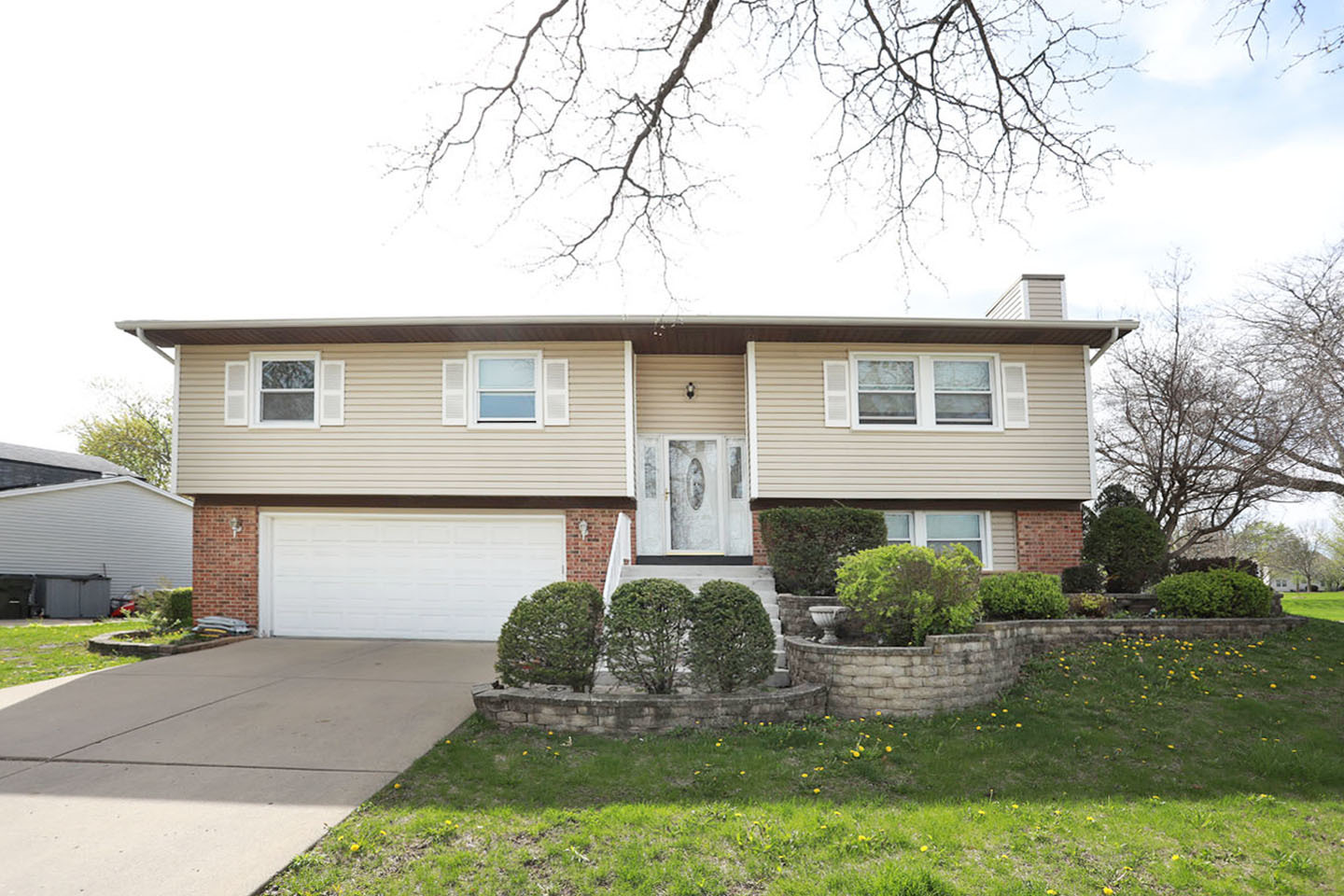 4624 Thornbark Drive Hoffman Estates, IL 60192 - Photo 1 of 30 a front view of a house with a yard garage and outdoor seating