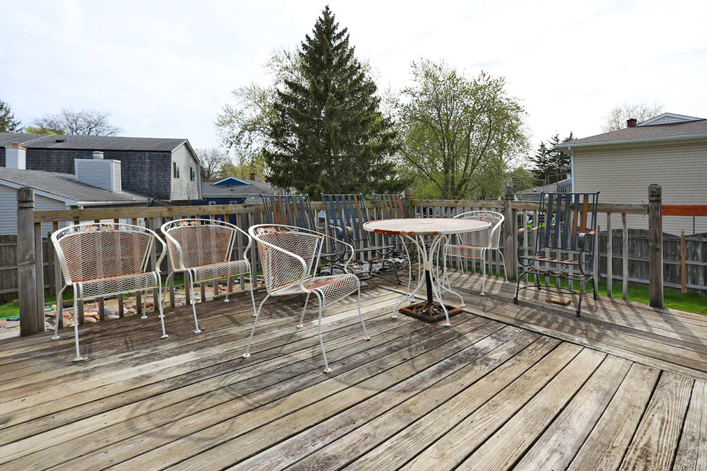 4624 Thornbark Drive Hoffman Estates, IL 60192 - Photo 27 of 30 a view of a roof deck with table and chairs with wooden floor and fence