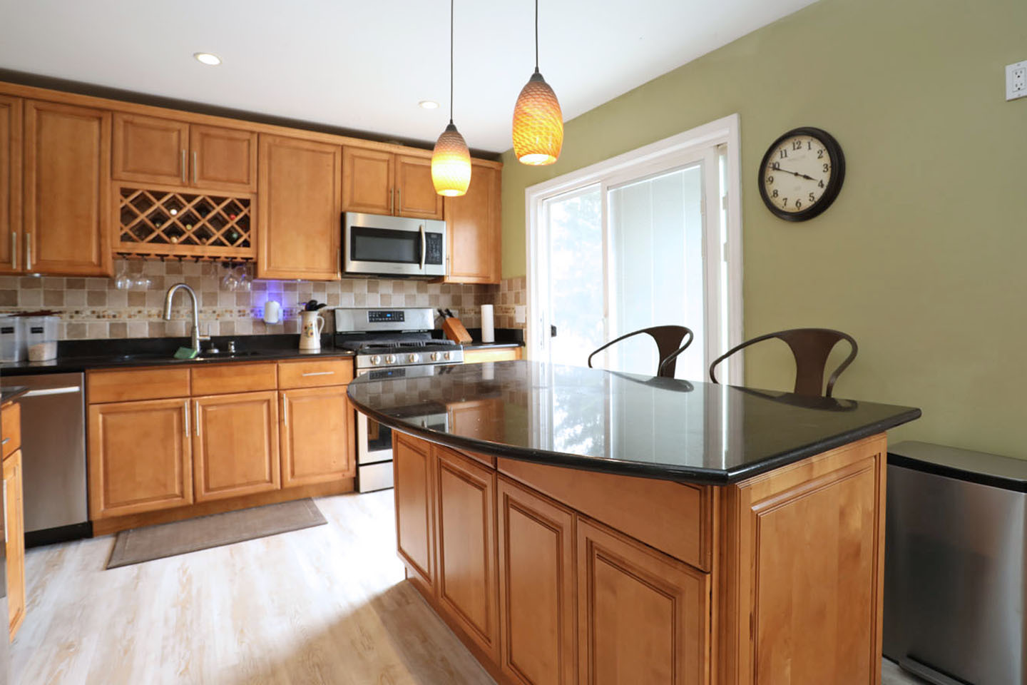 4624 Thornbark Drive Hoffman Estates, IL 60192 - Photo 4 of 30 a kitchen with stainless steel appliances granite countertop a sink a stove and a wooden floors
