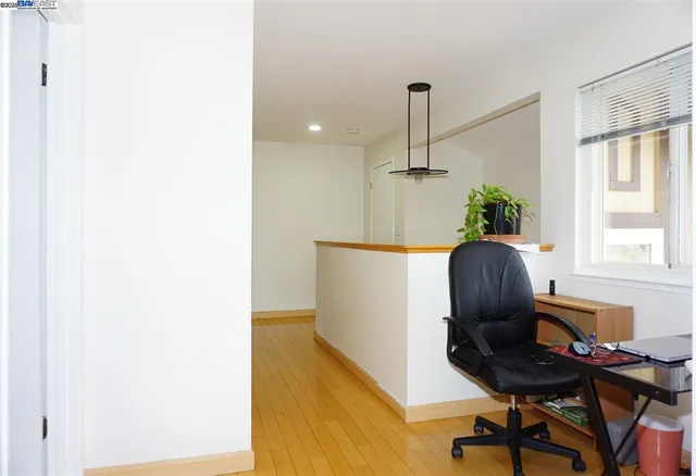 a view of a workspace with furniture and a window