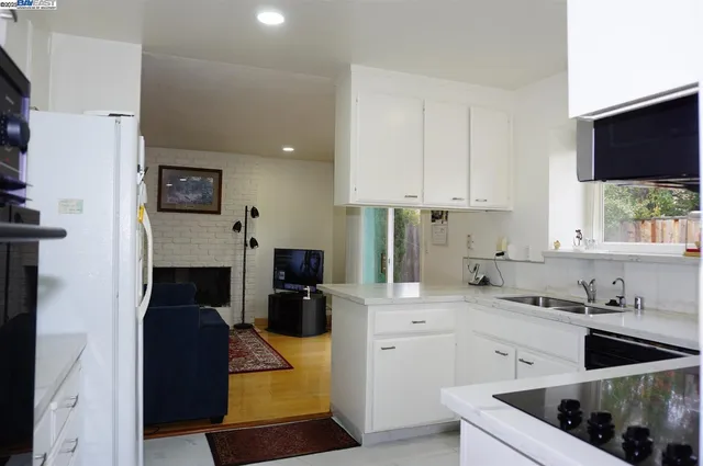 a kitchen with a stove a refrigerator and a sink