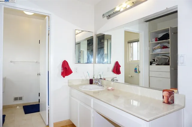 a bathroom with a sink vanity and tub