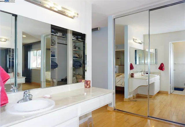 a bathroom with a tub sink and mirror