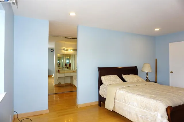 a bedroom with a bed and glass door