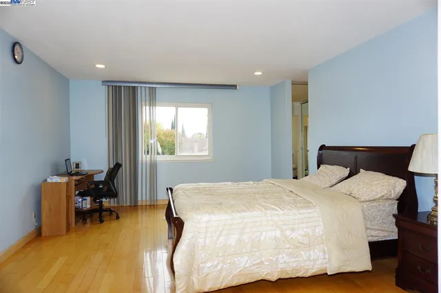 a bedroom with a bed and a table