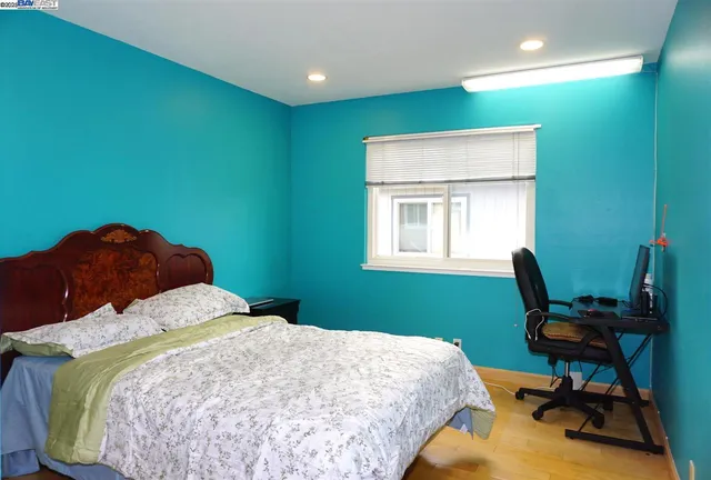 a bedroom with a bed chair and a window