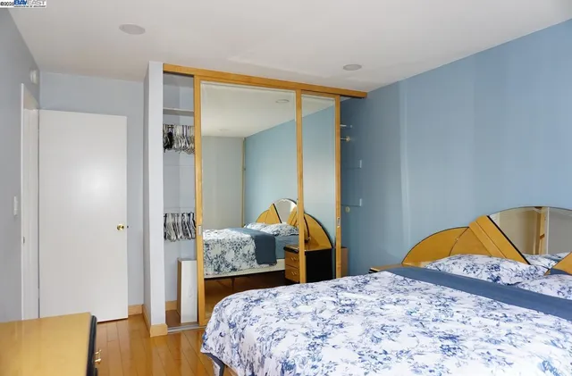 a bedroom with a bed and a dresser in it