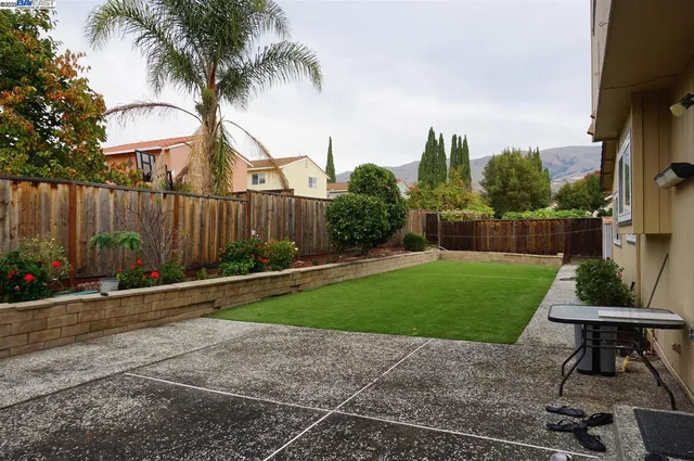 a view of a backyard with furniture and a garden