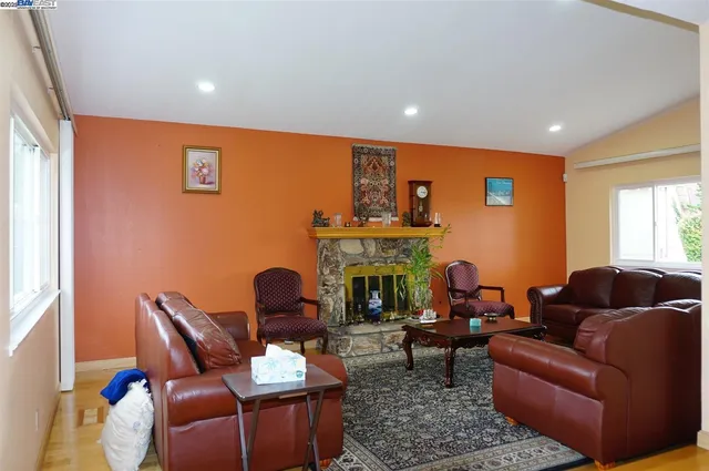 a living room with furniture and a fireplace