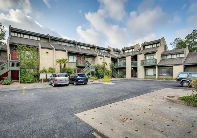 a view of a car park in front of house