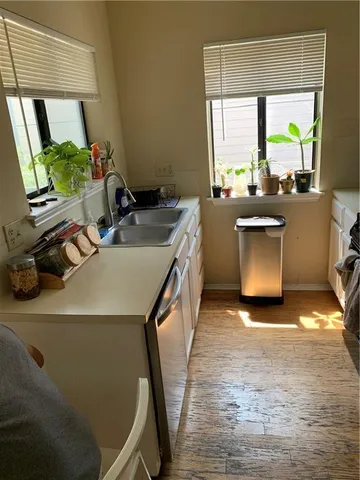 a kitchen with a sink stove and cabinets