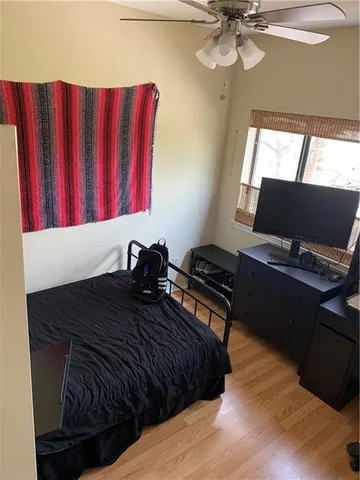 a bedroom with a bed and a window