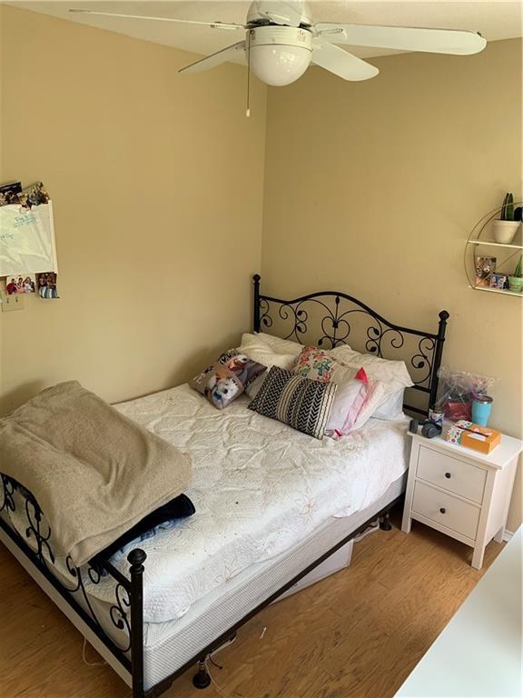 601 Nelray Boulevard, Unit 15 Austin, TX 78751 - Photo 5 of 6 a bedroom with a bed and a table