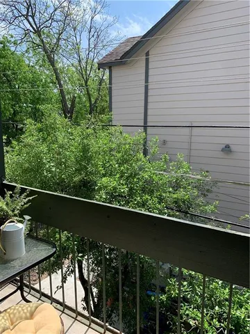 a view of a chair and table in the balcony