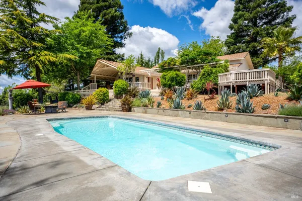 an outdoor space with swimming pool and furniture