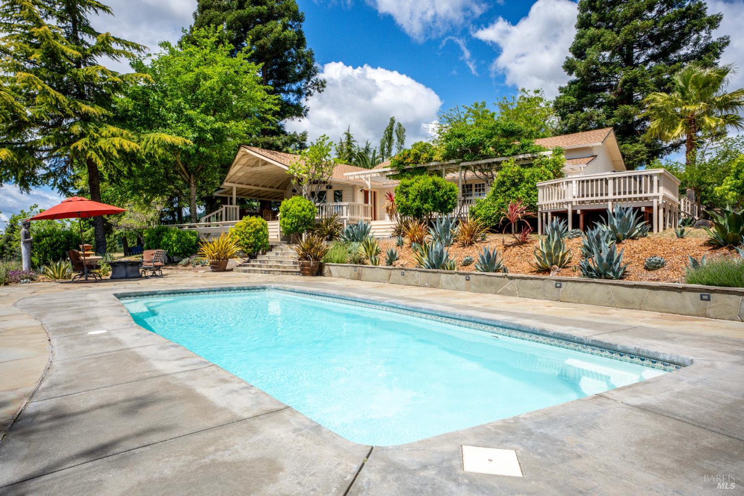 an outdoor space with swimming pool and furniture