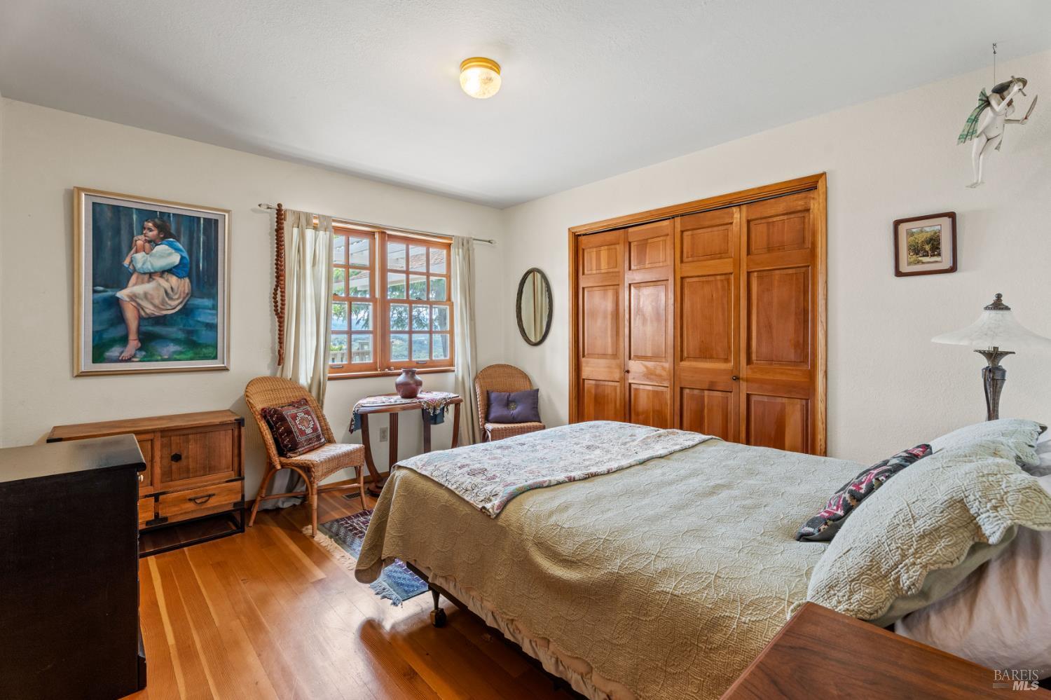 3760 King Ranch Road Ukiah, CA 95482 - Photo 14 of 44 a bedroom with a bed and wooden floor