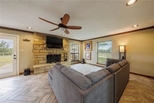 a living room with fireplace furniture and a flat screen tv