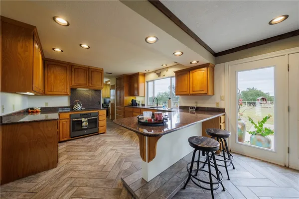 a kitchen with granite countertop lots of counter top space and stainless steel appliances
