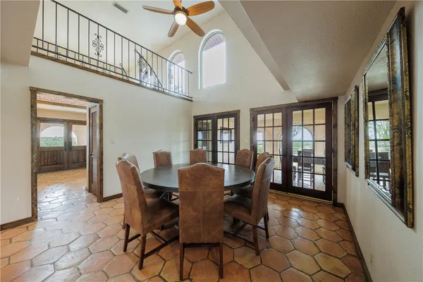a dining room with furniture a rug and a large window