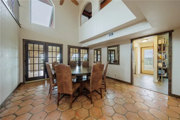 a view of a dining room with furniture and chandelier