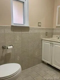a bathroom with a toilet a sink a mirror and shower