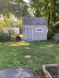 a view of a backyard with a small cabin