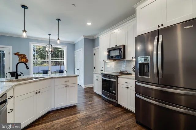 a kitchen with stainless steel appliances and white cabinets