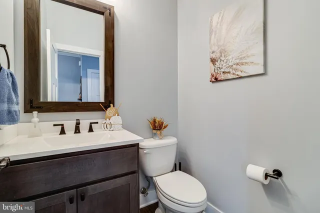 a bathroom with a toilet a sink and mirror