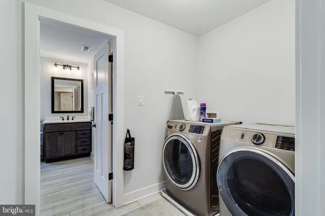 a view of a storage and utility room with washer and dryer