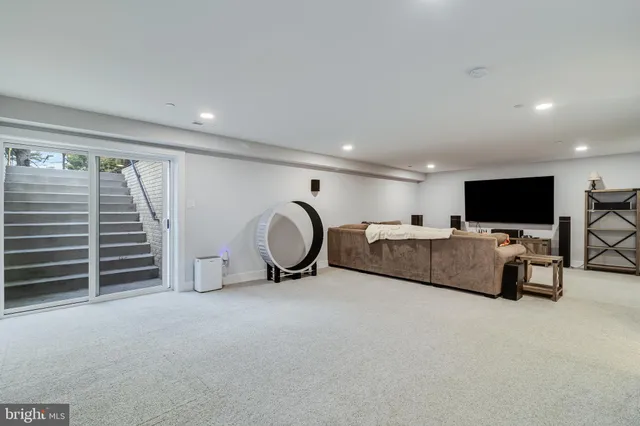 a view of a livingroom with furniture and a flat screen tv