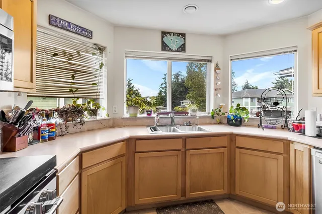 a kitchen with sink and large window