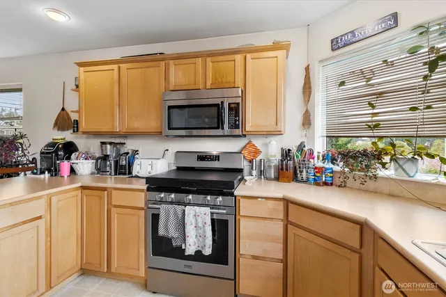 a kitchen with a stove a sink and a microwave