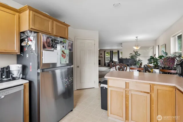 a kitchen with refrigerator and cabinets